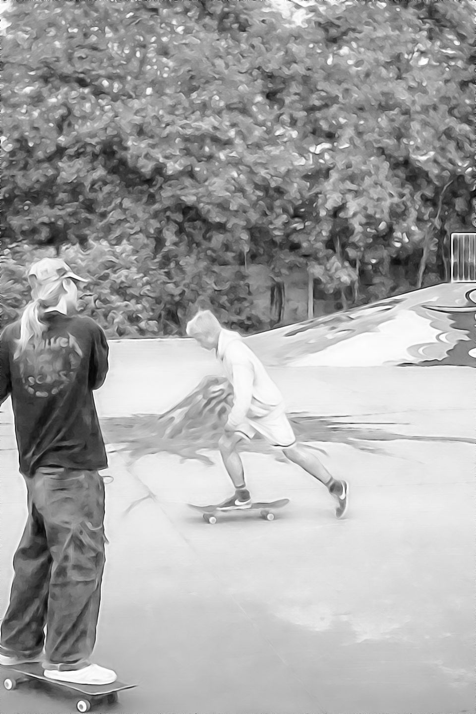Black-and-white ink wash style image of two skateboarders at an outdoor skatepark. One skateboarder pushes across the concrete surface while another stands on a skateboard nearby, with graffiti-covered ramps and trees in the background.